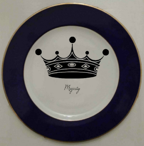 Crown image on face of black and gold charger plate
