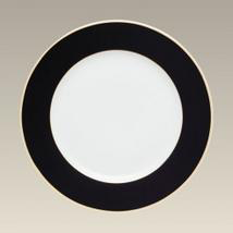 black rimmed dinner plate with gold trim around edge
