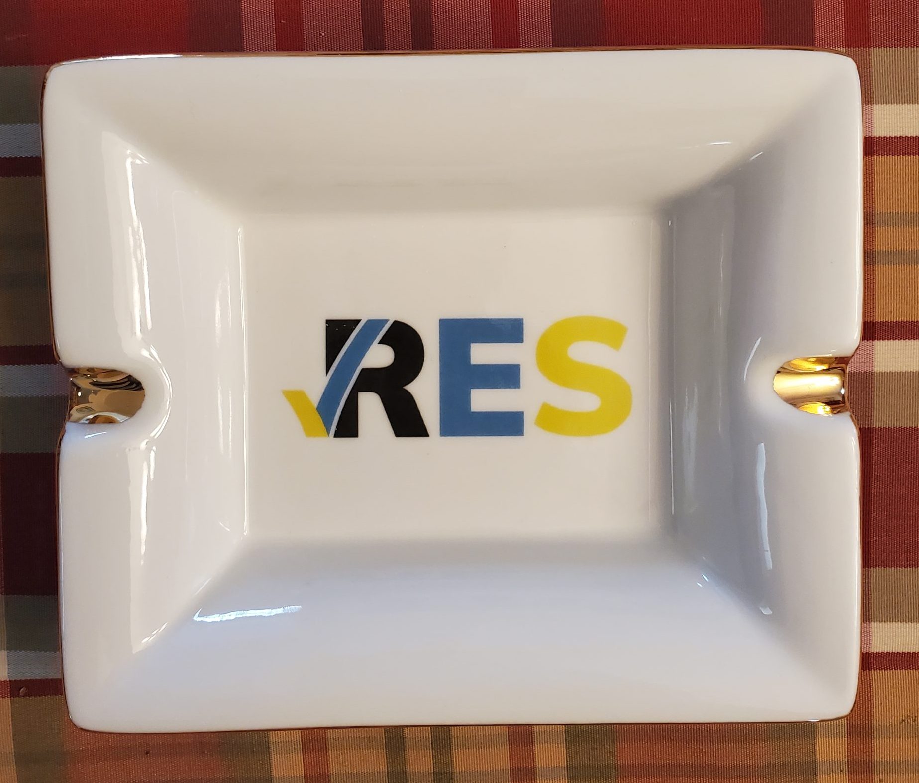 Custom printed 22kt gold-rimmed porcelain ashtray with RES company logo