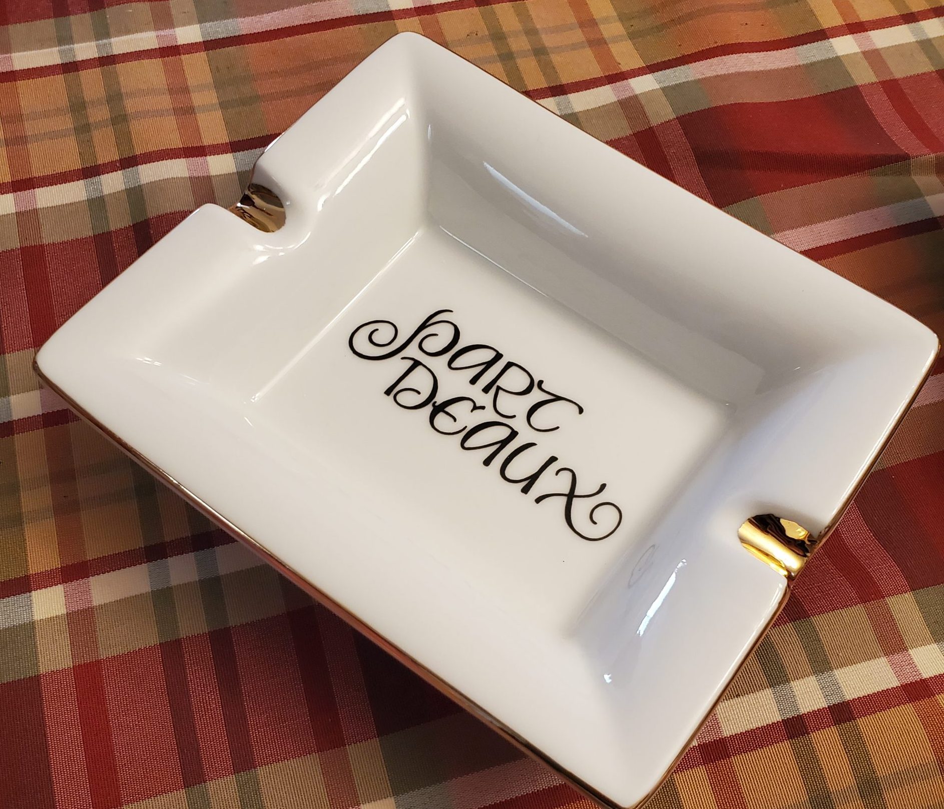 Personalized gold rimmed porcelain cigar ashtray printed with a custom name in calligraphy style