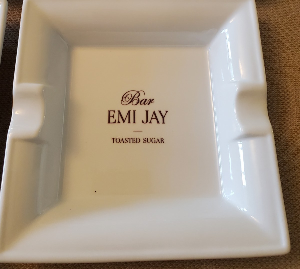 Custom printed white porcelain ashtray for Emi Jay Bar with kiln-fired artwork